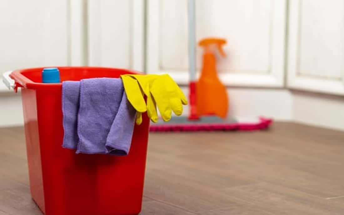 Cleaning supplies ready in a bright empty room for a SoHo Home Multiservices move-out deep clean